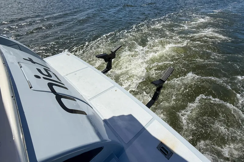 Slide: The Image of Stern view of 2018 Marlow 53E yacht cruising on water, showing wake and swim platform. - 93