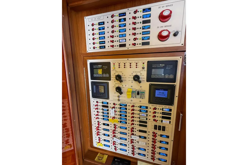 Slide: The Image of Electrical control panel on a 2018 Marlow 53E yacht, featuring switches and displays. - 94