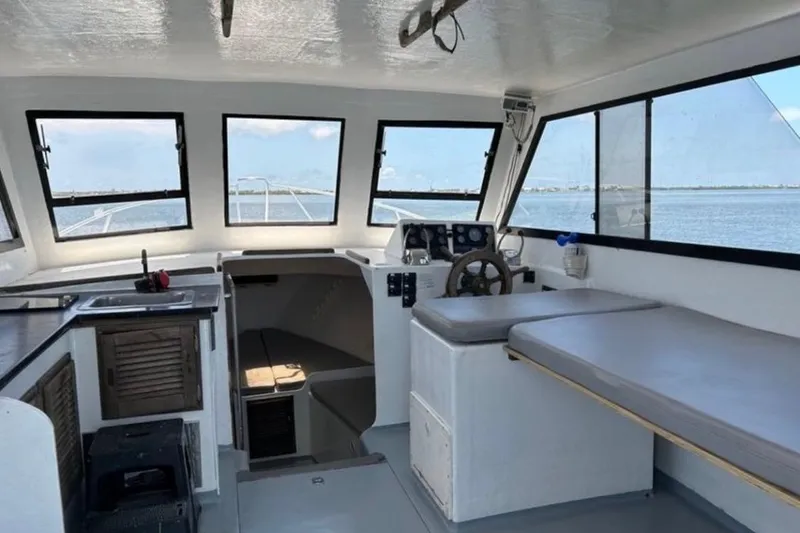 Slide: The Image of Interior of 2005 Crusader 34 SF boat with helm, seating, and kitchenette. - 3
