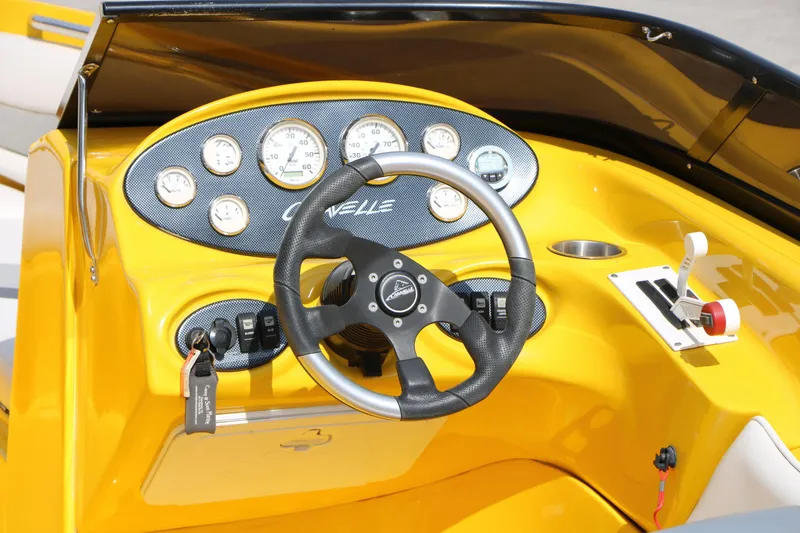Slide: The Image of Yellow dashboard of 2012 Caravelle Interceptor 232 Bow Rider with steering wheel and gauges. - 18
