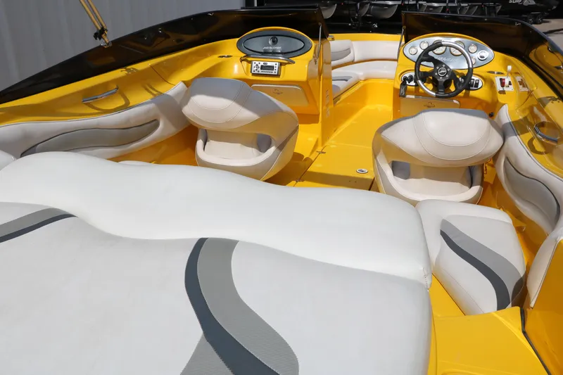 Slide: The Image of 2012 Caravelle Interceptor 232 Bow Rider interior with yellow and white seating and dashboard. - 19