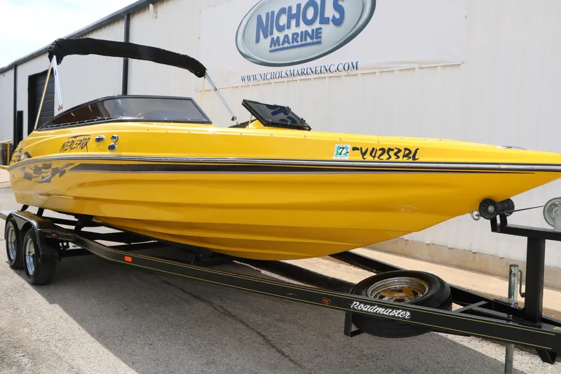 Slide: The Image of Yellow 2012 Caravelle Interceptor 232 Bow Rider boat on trailer at Nichols Marine. - 3