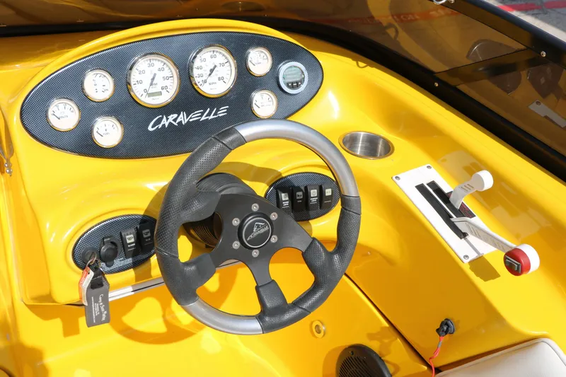 Slide: The Image of Yellow dashboard of 2012 Caravelle Interceptor 232 Bow Rider with steering wheel and gauges. - 35
