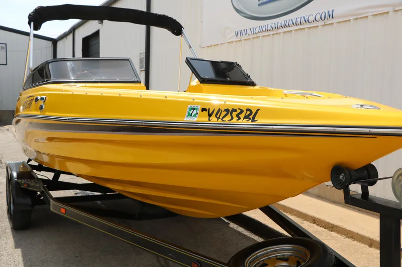 Slide: The Image of 2012 Caravelle Interceptor 232 Bow Rider in vibrant yellow on trailer. - 4