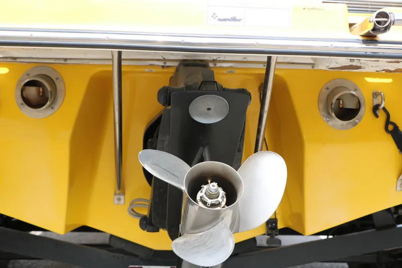 Slide: The Image of Rear view of 2012 Caravelle Interceptor 232 Bow Rider with propeller and yellow hull. - 9