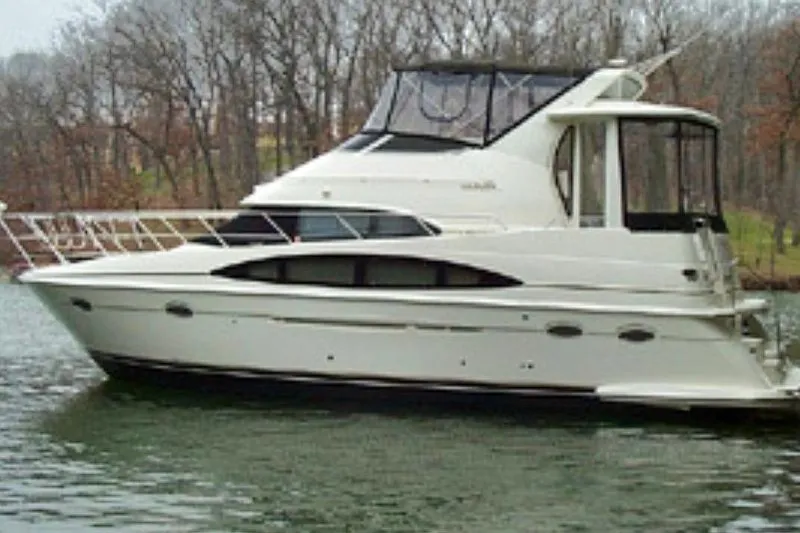 The Image of 2000 Carver 396 Motor Yacht on a calm lake with wooded background. - 0