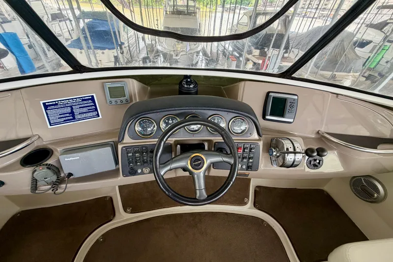 Slide: The Image of Helm of 2000 Carver 396 Motor Yacht with steering wheel and navigation instruments. - 10