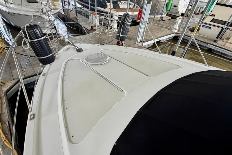 Slide: The Image of 2000 Carver 396 Motor Yacht docked, showcasing spacious deck and sleek design. - 14