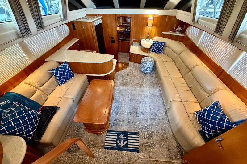 Slide: The Image of Luxurious interior of a 2000 Carver 396 Motor Yacht with beige seating and nautical decor. - 16
