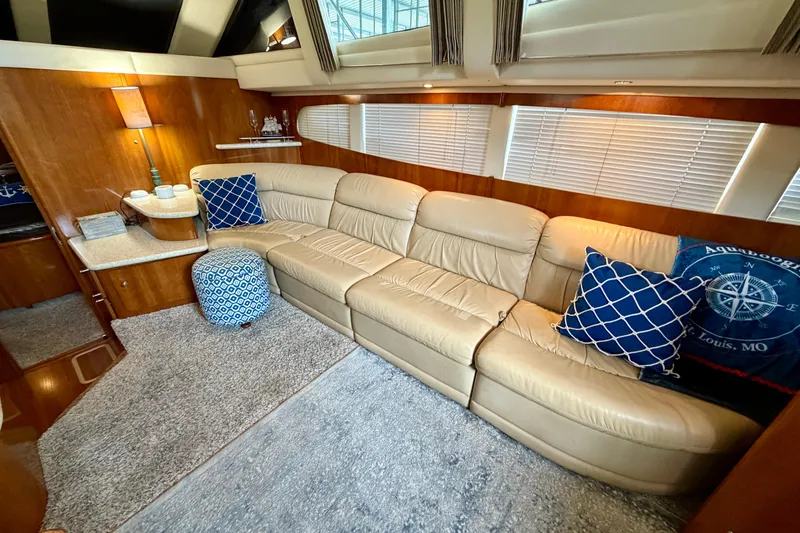 Slide: The Image of Luxurious interior of 2000 Carver 396 Motor Yacht with beige leather seating and nautical decor. - 17