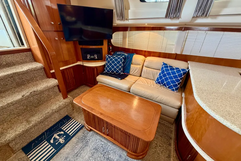 Slide: The Image of Luxurious interior of 2000 Carver 396 Motor Yacht with cozy seating and elegant wood finishes. - 18