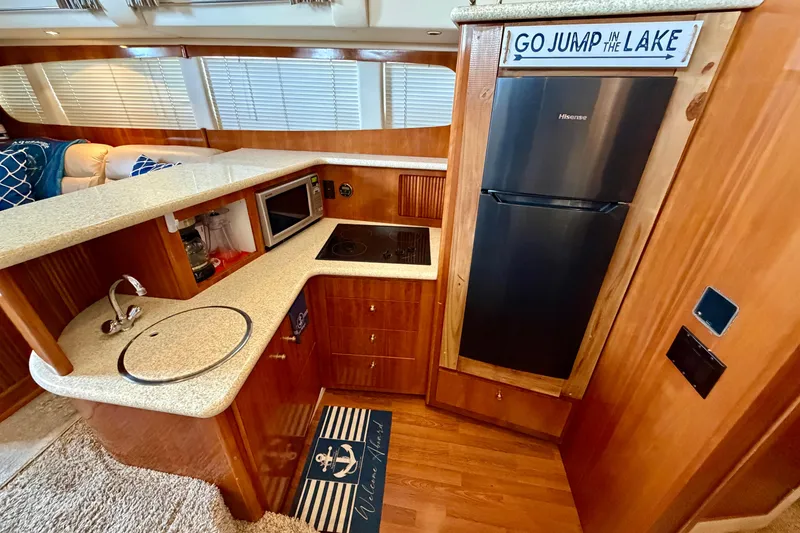 Slide: The Image of Interior of 2000 Carver 396 Motor Yacht kitchen with appliances and nautical decor. - 19