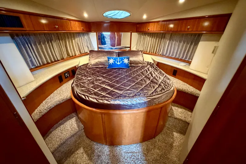 Slide: The Image of Luxurious bedroom interior of 2000 Carver 396 Motor Yacht with plush bedding and wood accents. - 20