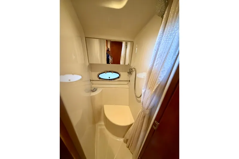 Slide: The Image of Bathroom interior of 2000 Carver 396 Motor Yacht with shower and porthole window. - 21