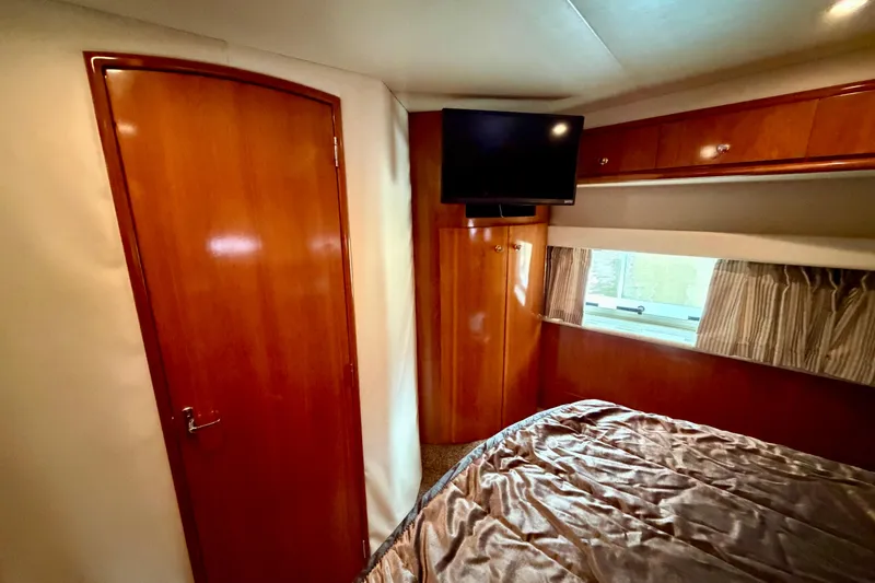 Slide: The Image of Luxurious interior of 2000 Carver 396 Motor Yacht with wood finish and TV. - 26