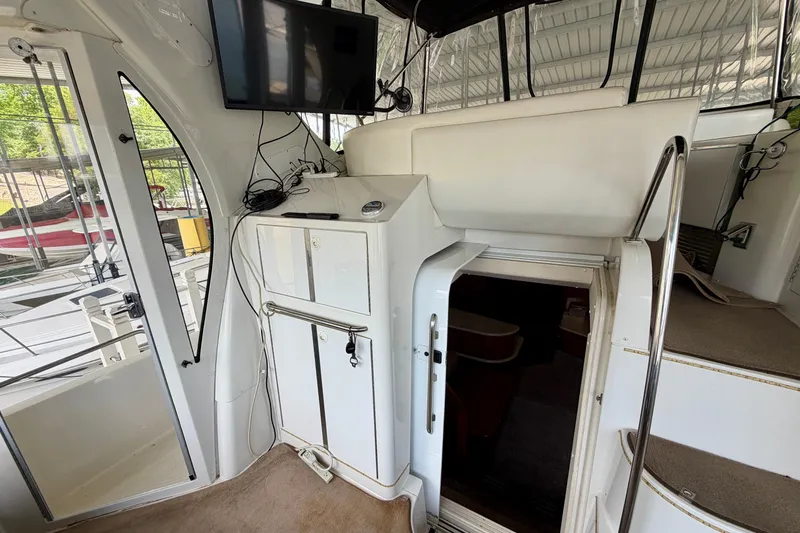Slide: The Image of Interior view of a 2000 Carver 396 Motor Yacht with stairs and a mounted TV. - 6