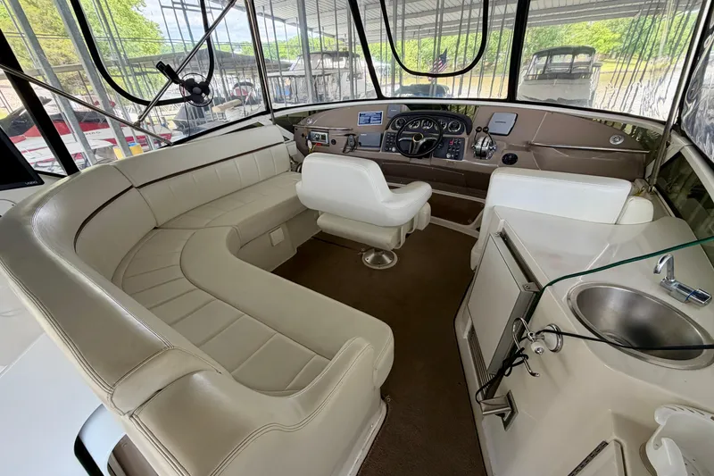Slide: The Image of Interior of 2000 Carver 396 Motor Yacht with plush seating and modern helm controls. - 7