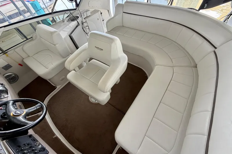 Slide: The Image of Interior of 2000 Carver 396 Motor Yacht with white leather seating and steering wheel. - 8