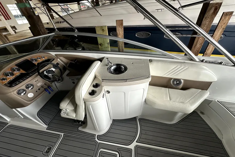 Slide: The Image of 2008 Cobalt 302 boat interior with helm, seating, and sink area. - 5