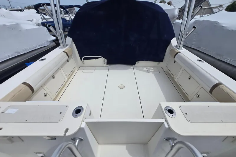 Slide: The Image of 2015 World Cat 295 DC boat interior with seating and storage compartments. - 10
