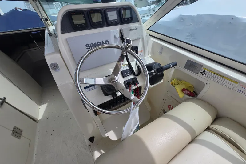 Slide: The Image of 2015 World Cat 295 DC boat helm with Simrad electronics and steering wheel. - 13