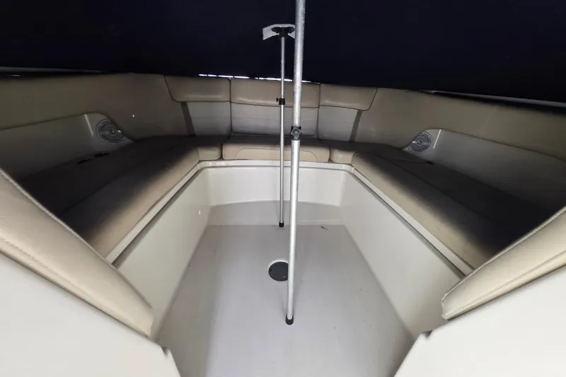 Slide: The Image of Interior view of 2015 World Cat 295 DC boat with beige seating and central pole. - 14
