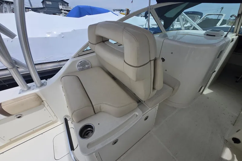 Slide: The Image of 2015 World Cat 295 DC boat interior with beige seating and cup holder. - 17