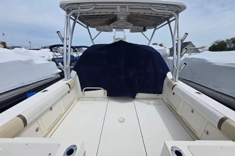 Slide: The Image of 2015 World Cat 295 DC boat interior with seating and storage compartments. - 2