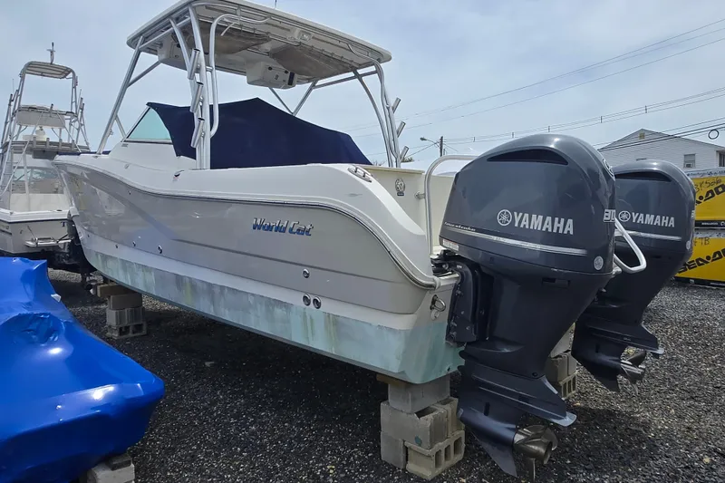 Slide: The Image of 2015 World Cat 295 DC boat with twin Yamaha outboard engines on blocks. - 21