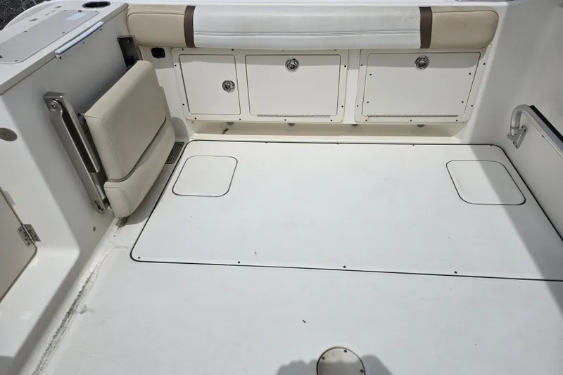 Slide: The Image of 2015 World Cat 295 DC boat interior with storage compartments and seating. - 23