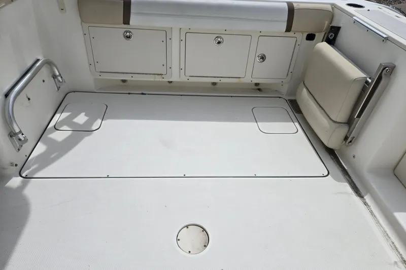 Slide: The Image of 2015 World Cat 295 DC boat interior with storage compartments and seating. - 24