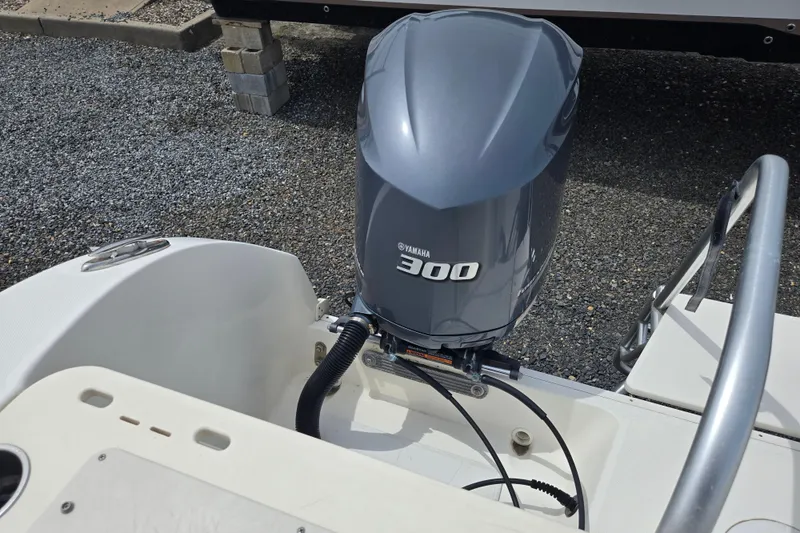 Slide: The Image of 2015 World Cat 295 DC boat with Yamaha 300 outboard motor, parked on gravel. - 25