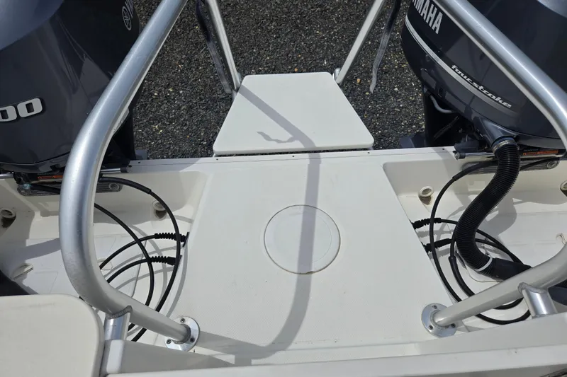 Slide: The Image of 2015 World Cat 295 DC boat stern with Yamaha outboard engines and railing. - 27