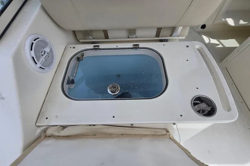 Slide: The Image of Livewell on 2015 World Cat 295 DC boat with speaker and cup holder. - 28