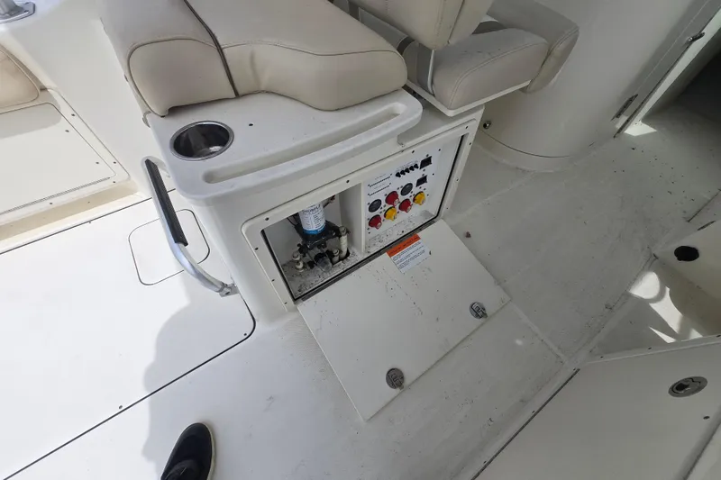 Slide: The Image of 2015 World Cat 295 DC boat interior with open control panel and seating. - 29