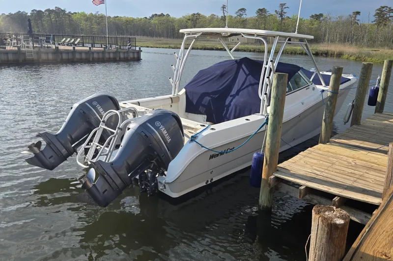 Slide: The Image of 2015 World Cat 295 DC boat docked with twin Yamaha outboard engines. - 3