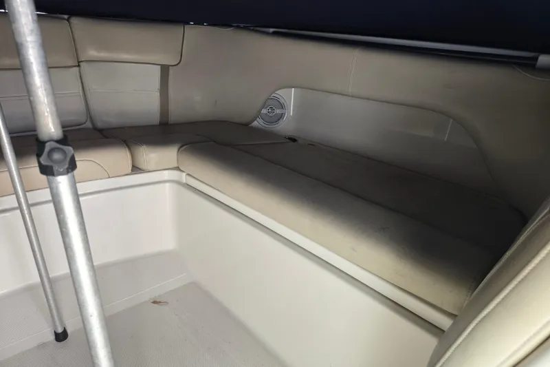 Slide: The Image of Interior seating of a 2015 World Cat 295 DC boat, featuring beige upholstery. - 31