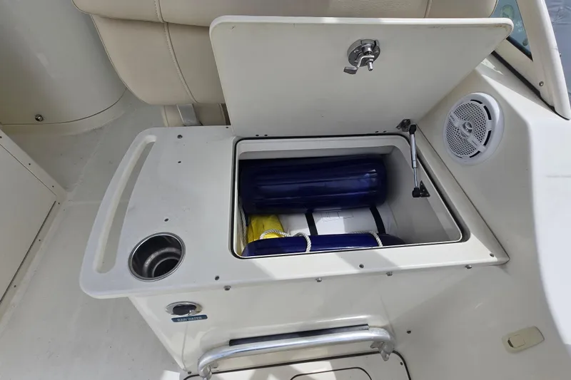 Slide: The Image of Storage compartment on 2015 World Cat 295 DC boat with safety equipment and speaker. - 32