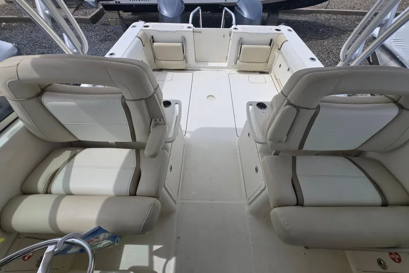 Slide: The Image of Interior of 2015 World Cat 295 DC boat with beige seating and spacious layout. - 7