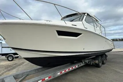 The Image of 2020 Pursuit OS 325 Offshore boat on trailer, ready for launch. - 0
