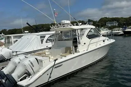 Slide: The Image of 2020 Pursuit OS 325 Offshore boat docked, featuring twin Yamaha engines, in a marina setting. - 5
