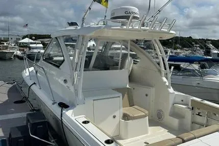 Slide: The Image of 2020 Pursuit OS 325 Offshore boat docked at marina, featuring sleek design and modern amenities. - 6