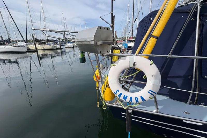 Slide: The Image of 1977 Folkes Full Keel Offshore Cutter docked, featuring lifebuoy labeled "Samara II." - 14