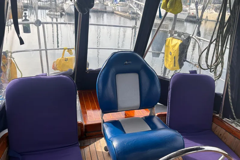 Slide: The Image of Cockpit of 1977 Folkes Full Keel Offshore Cutter with blue and purple seating. - 19