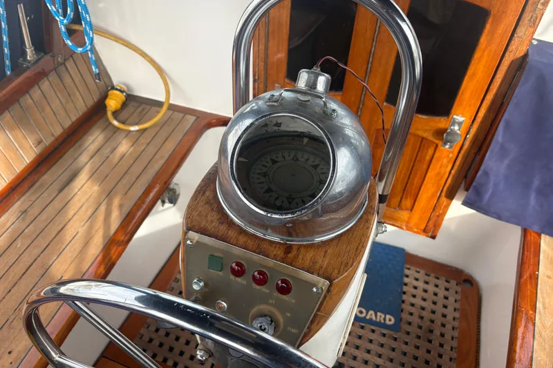 Slide: The Image of 1977 Folkes Full Keel Offshore Cutter helm with compass and wooden details. - 21
