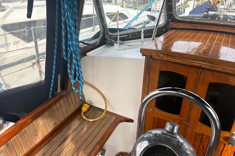 Slide: The Image of Interior of 1977 Folkes Full Keel Offshore Cutter with wooden seating and nautical equipment. - 22