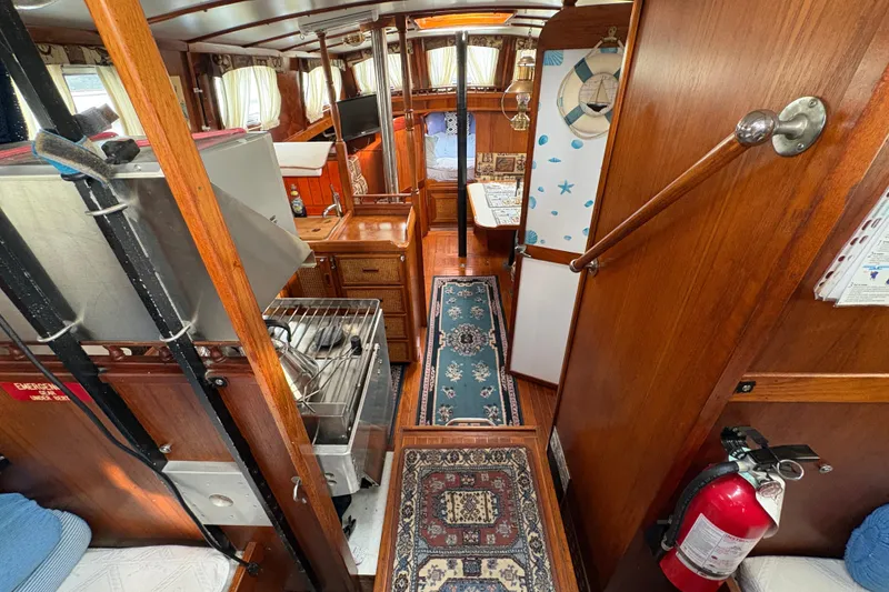 Slide: The Image of Interior of 1977 Folkes Full Keel Offshore Cutter, featuring wood paneling and nautical decor. - 33