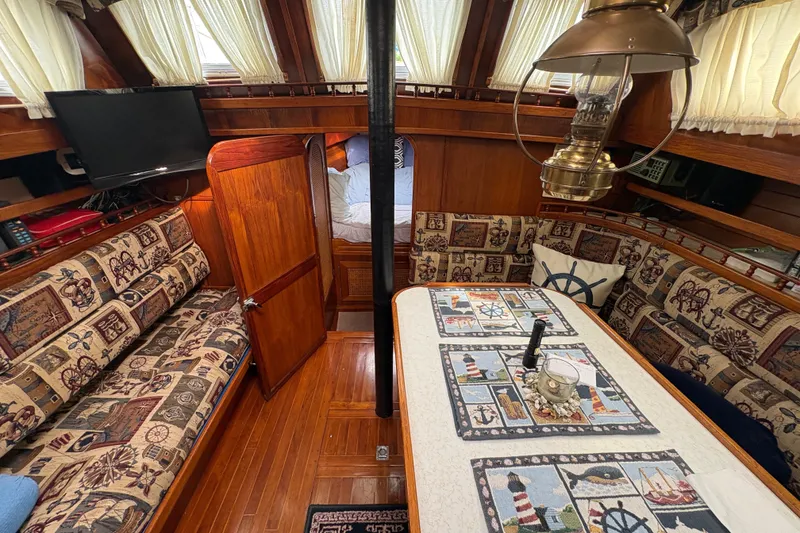 Slide: The Image of Interior of 1977 Folkes Full Keel Offshore Cutter with nautical-themed decor and cozy seating. - 37