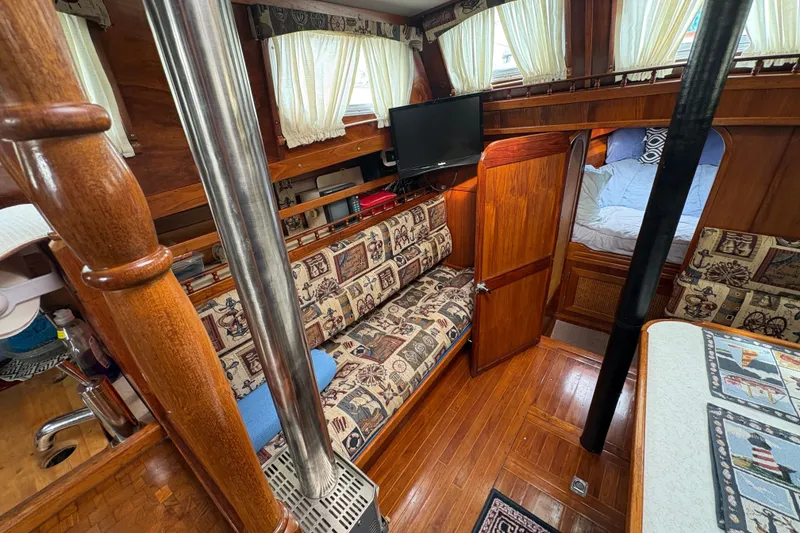 Slide: The Image of Cozy interior of 1977 Folkes Full Keel Offshore Cutter with wood finish and patterned upholstery. - 39