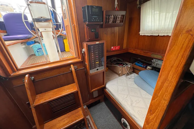 Slide: The Image of Interior of 1977 Folkes Full Keel Offshore Cutter with wooden paneling and navigation equipment. - 56